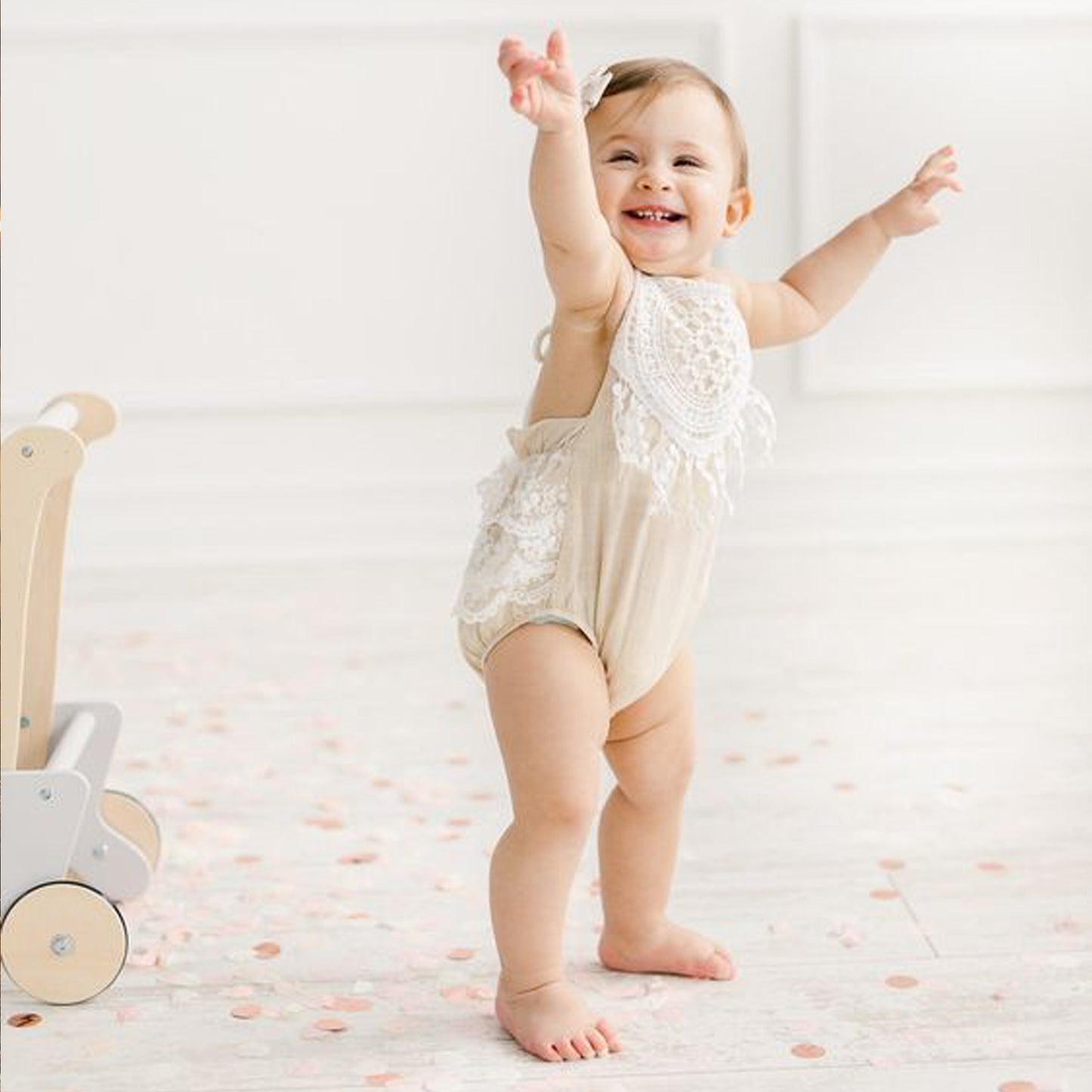 Lace beige baby girl romper for the First BirthdayCake Smash photoshoot.