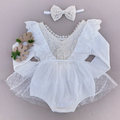 Lace toddler outfit with a bow on the head.