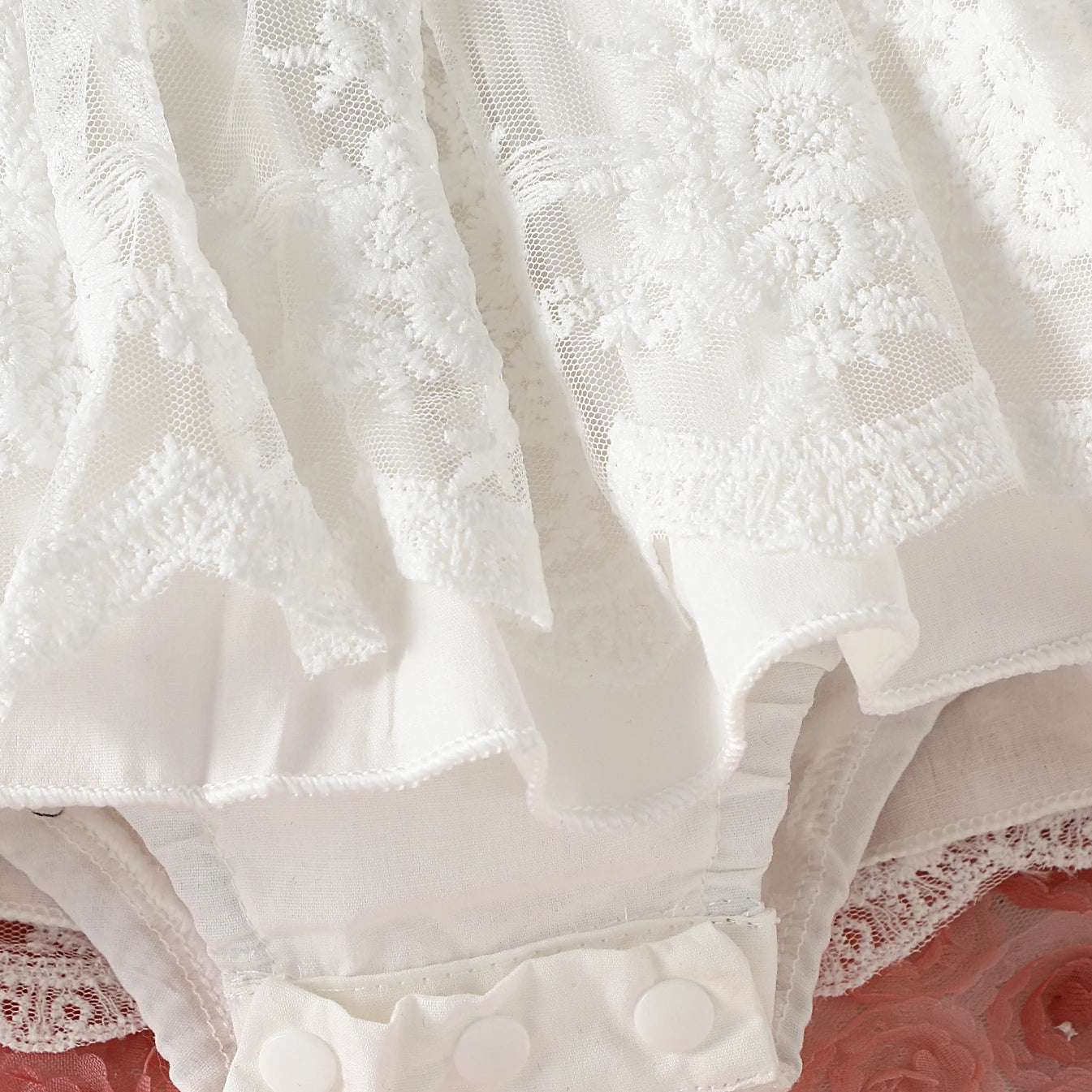 White lace baby girl dress with floral print for family photoshoot.