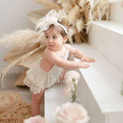 Beige lace floral romper for Newborn photoshoot.