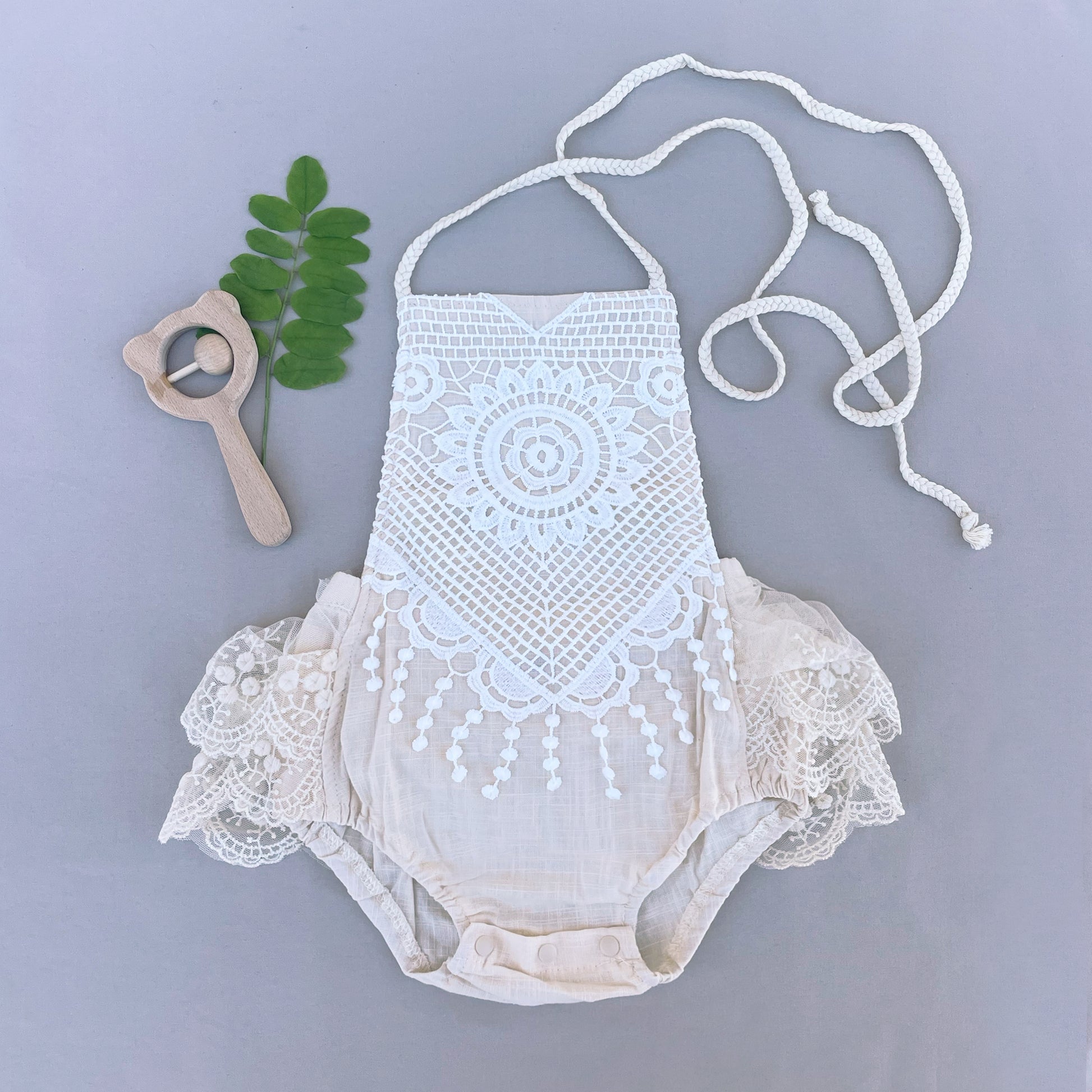 Beige lace baby girl romper for summer holidays.